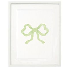 a green bow is hanging in a white frame with watercolor paint on it's paper