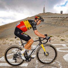 a man riding a bike on top of a road