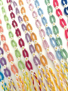 many different colored braids are arranged on the wall