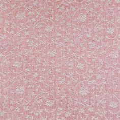 a pink and white textured fabric with small flowers on the side, as well as an intricate design