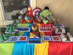 the table is set up with avengers themed treats