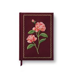 a red notebook with pink flowers on it