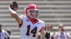 a football player throwing a ball during a game