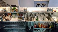 a kitchen with stainless steel appliances and lots of bottles