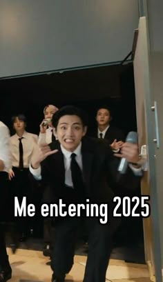 a man in a suit and tie is dancing with other men behind him that says me entering 2055