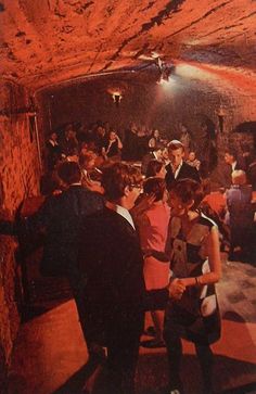 a group of people standing inside of a tunnel