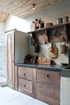 a kitchen with wooden cabinets and hanging pots