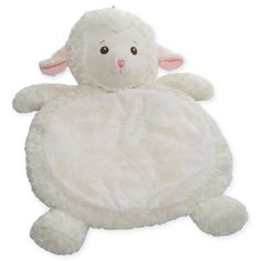 a white stuffed sheep sitting on top of it's back legs with its eyes closed