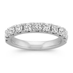 a white gold wedding band with five round diamonds on the top and bottom, set in 18k white gold