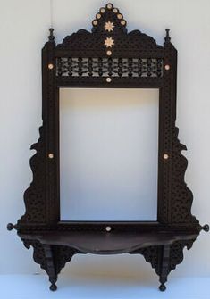 an ornate wooden shelf with a mirror on it