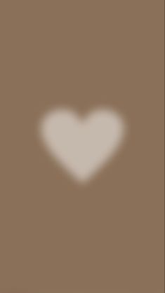 a white heart on a brown background with the shadow of a person's head