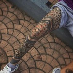 a man with a tattoo on his arm and leg