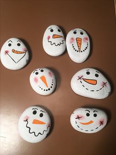 six painted rocks with faces on them