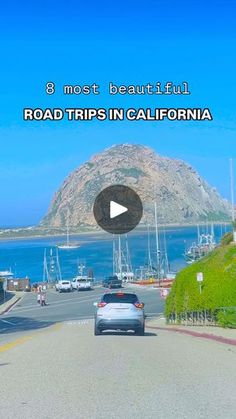 a car is driving down the road in california