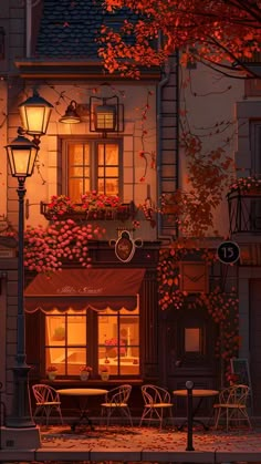 an image of a street scene at night with autumn leaves on the windows and tables outside