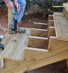 a man is using a drill to build a deck