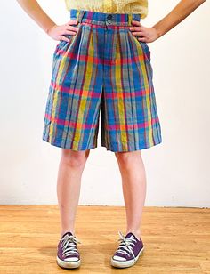 This is a fabulous pair of 80s vintage "Giorgio Sant'Angelo" rainbow plaid shorts! They are a linen cotton blend, woven with a lovely palette in shades of yellow, blue, red and purple. The high waist has four wide belt loops. There are two vertical welted front pockets and one inset back pocket on the right which buttons to close. They're unlined and have a 1" hem allowance. These cute shorts have a pleated front, a Bermuda shape, and close with two small front buttons and a gray "RJ" brand nylo Retro Short Bottoms With Elastic Waistband, Casual Multicolor Short Pants, Retro Cotton Bottoms With Short Length, Retro Plaid Bottoms For Spring, Multicolor Bermuda Bottoms For Spring, Retro Bermuda Shorts For Summer, Casual Multicolor Bermuda Bottoms, Multicolor Casual Shorts, Casual Multicolor Short Leg Bottoms