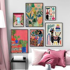 a living room filled with lots of art on the wall next to a white couch