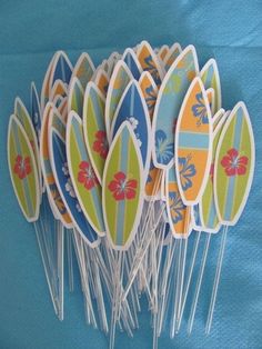 a bunch of pins with surfboards on them sitting in front of a blue background