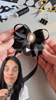 a woman is holding a hair bow in her hands