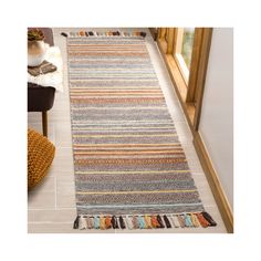 a multicolored striped rug on the floor