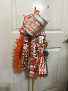 an orange and silver candy bar decoration on a door