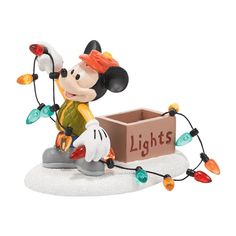 a mickey mouse figurine with lights on it's feet and head in a box