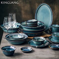 a table topped with lots of blue dishes