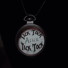 a close up of a clock on a chain with the words alice and jack in it