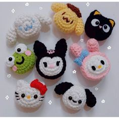 several crocheted items are arranged in the shape of cats and panda, including an owl