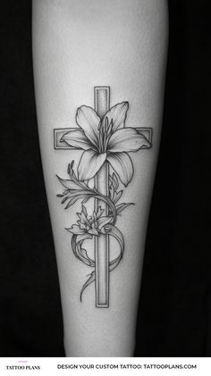 a cross with flowers on it and a ribbon around the cross is shown in this tattoo design