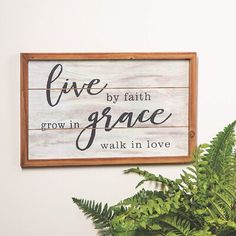 a wooden sign that says live by faith, grow in grace and walk in love