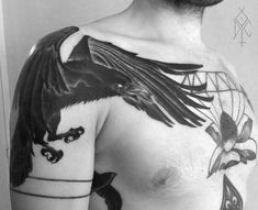 a man with a bird tattoo on his chest