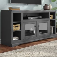 an entertainment center in a living room with a flat screen tv