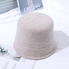 The Emes Shop hat is detailed with a sleek minimalist design. Features a solid color. wool material. and cloche hat design.MATERIAL:100% Brushed Wool BlendCIRCUMFERENCE MEASUREMENTS: 56-58cm 22-23in Beige Winter Fedora Hat, Beige Fedora Winter Hat, Beige Wide Brim Felt Hat For Winter, Beige Brimmed Felt Hat For Winter, Wide Brim Beige Felt Hat For Winter, Classic Fall Cloche Hat, Classic Solid Cloche Hat For Fall, Classic Solid Color Cloche Hat For Fall, Winter Wool Cloche Hat