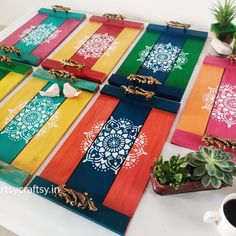 a table topped with lots of colorful place mats and succulents on top of it