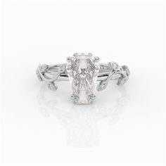 an oval cut diamond ring with leaves on the band and side stones set in 18k white gold