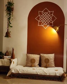 a bed sitting in front of a red wall with decorative decorations on the headboard