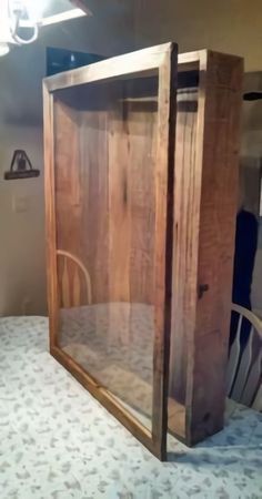 an old wooden cabinet sitting on top of a bed