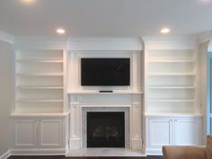 a living room filled with furniture and a flat screen tv mounted on the wall above a fireplace