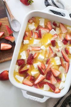 a casserole dish with strawberries and cheese