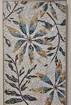 a mosaic tile with leaves on it