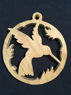 a wooden ornament with an image of a bird on it's back