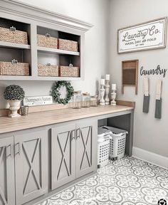 a white and gray laundry room with lots of storage