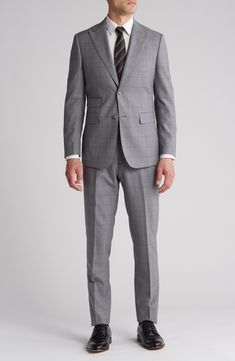 Sophisticated peaked lapels smarten the jacket of this trim-fit suit crafted from a fine wool blend and finished in a handsome windowpane plaid print. 36 1/4" inseam; 7 3/4" leg opening; 10 1/2" rise (size 38R) Jacket has peaked lapels; chest welt pocket; front flap pockets Unhemmed Lined 90% wool, 10% polyester Dry clean Imported Single-breasted Pantsuit With Suit Collar, Tailored Suits With Lapel Collar For Office Wear, Tailored Pantsuit With Welt Pockets And Suit Collar, Tailored Single Button Suit, Slim Fit Suits With Welt Pockets And Suit Collar, Tailored Single-button Suit In Suiting Fabric, Tailored Notch Lapel Pantsuit For Semi-formal Occasions, Classic Tailored Pantsuit With Lapel Collar, Tailored Three-piece Suit With Notch Lapel