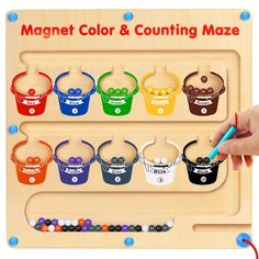 the magnetic color and counting maze is made from wooden pegs, with colorful buckets