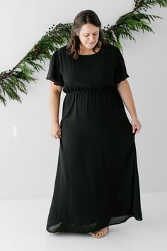 The modest formal maxi dress that you have been waiting for! The ‘Naomi’ is effortless and feminine - the perfect pick for family photos, an elegant party, or a modest bridesmaid dress. This timeless dress features a modest scoop neckline, flutter sleeves, and a chiffon overlay. The lightly gathered elastic waist and zipper closure allow for ease of styling and a flattering fit. This dress is fully lined - no layering required! Exclusively designed with you in mind. Self & Lining 100% Polyester Modest Flowy Floor-length Maxi Dress, Flowy Modest Floor-length Maxi Dress, Flowy Short Sleeve Maxi Dress For Wedding Guest, Modest Black Maxi Dress For Formal Occasions, Modest Floor-length Maxi Dress For Evening, Modest Long Sleeve Maxi Dress, Modest Flowy Maxi Dress, Modest Chiffon Maxi Dress For Party, Modest Chiffon Maxi Dress