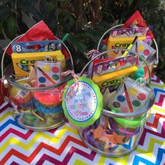 some candy and candies in plastic containers on a table