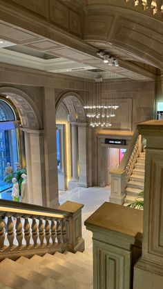 an elegant lobby with chandeliers and stairs