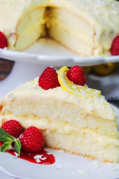 a slice of lemon cake with raspberries on the side and one piece missing